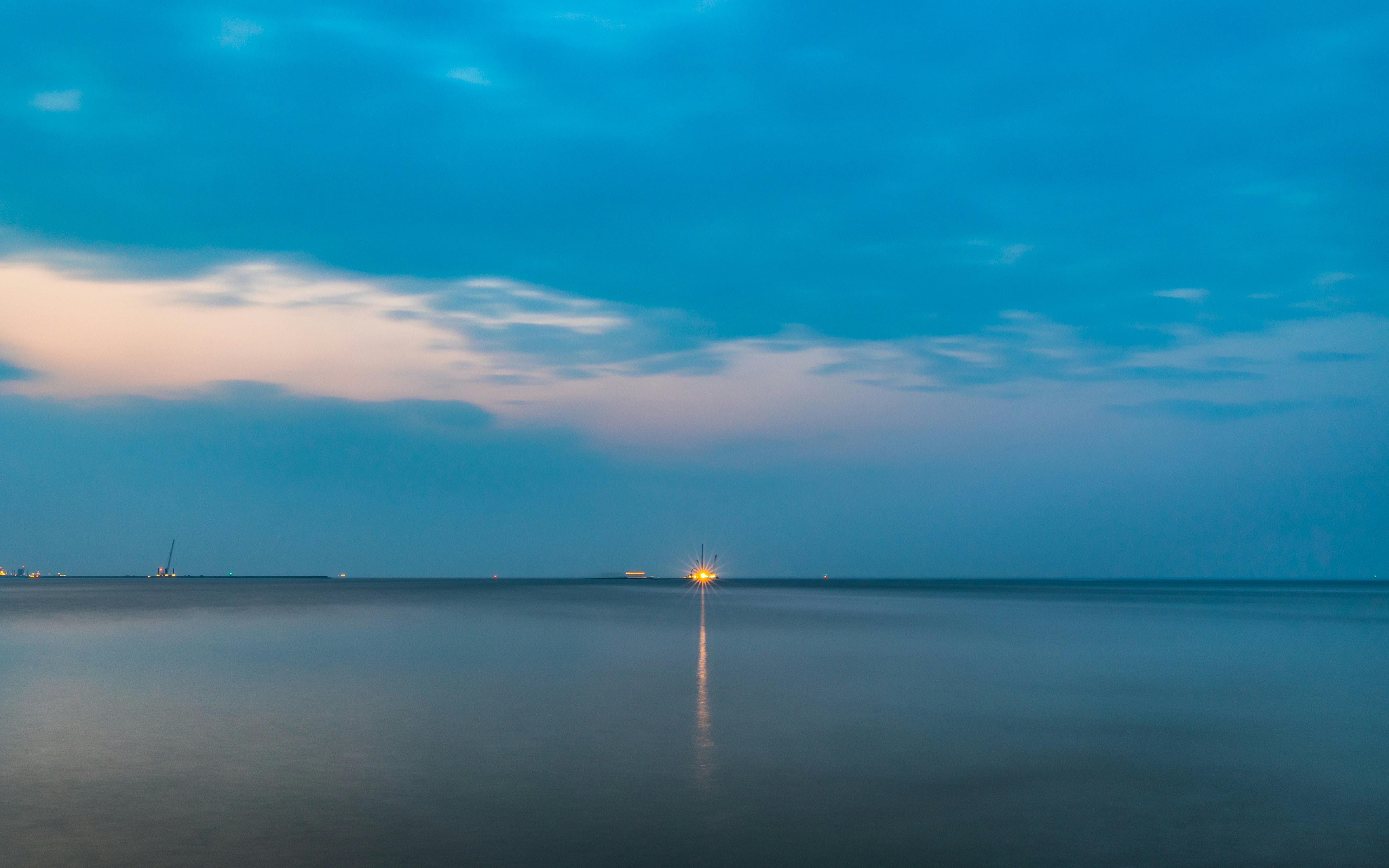 body of water under blue sky during daytime